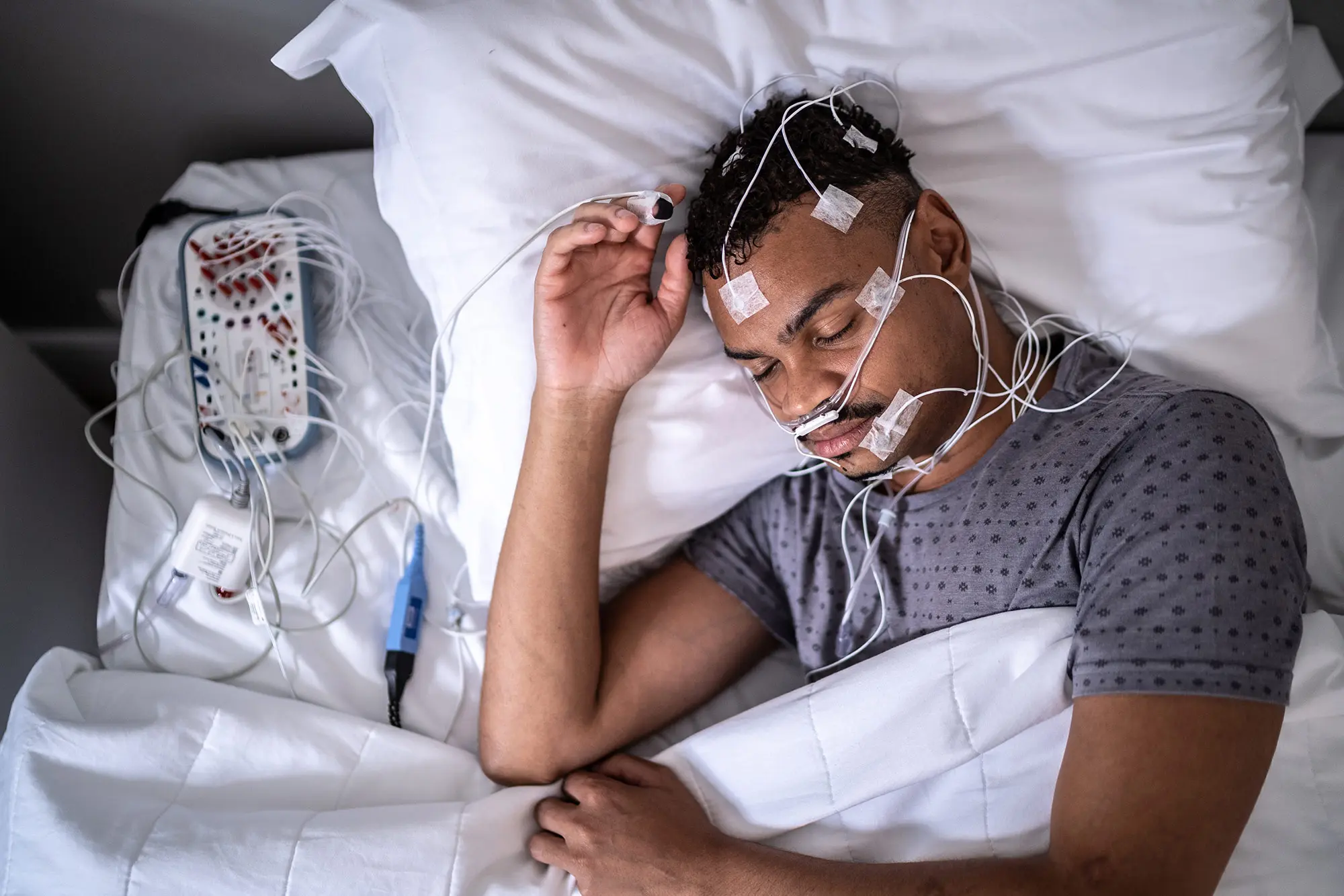 Patient asleep in a clinical setting during a sleep study