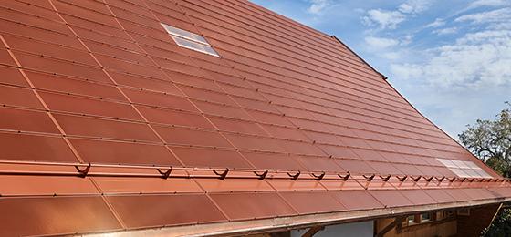 This photo shows the roof of a farmhouse with active terracotta tiles based on monocrystalline silicon cells.